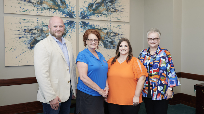 Staff Excellence Award recipients, Steven Koether, Debra Mikulin and Lacey Price take a photo with University President Alisa White.